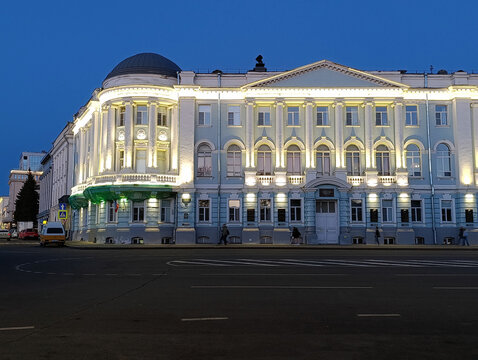 Magnificent neoclassical palace illuminated at blue hour, grand facade with columns and dome. Elegant night city landmark, perfect for architecture and luxury projects