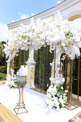Architectural arch decorated with white flowers. Festive decor.