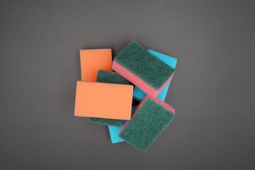 Discovering vibrant cleaning tools in various shapes and colors stacked artistically against a...