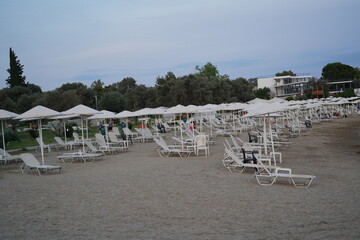 Serene holiday destination at a coastal beach with sun loungers and umbrellas in quiet afternoon...