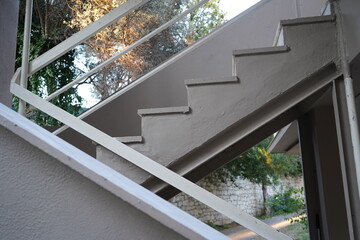 Stairs winding gracefully towards serene greenery in an afternoon light setting, revealing architectural elegance and natural beauty in harmony