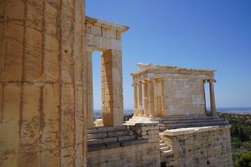 Exploring the ancient architecture of Athens reveals intricate details and stunning vistas beneath a clear blue sky