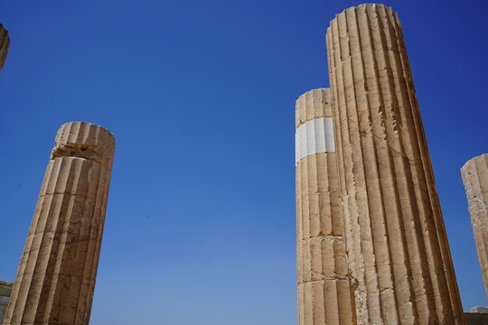 Ancient ruins stand tall against a clear sky, revealing traces of history and marvel in a forgotten realm of stunning architecture in a tranquil landscape