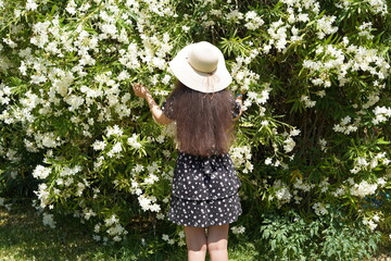 Enjoying a sunny day surrounded by blooming flowers in a picturesque garden while embracing the beauty of nature and the joy of outdoor exploration