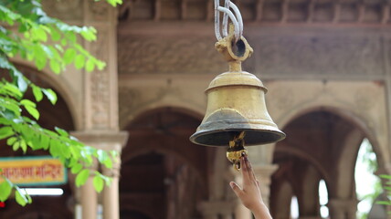 Close-up of a large temple bell in Govardhan, Uttar Pradesh, India — highlighting traditional...