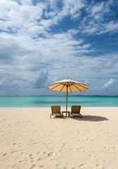 Tropical Beach with Lounge Chairs and Umbrella on White Sand with Clear Blue Sea