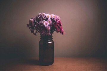 A Vase of Pink and Purple Delights Against a Subdued Backdrop
