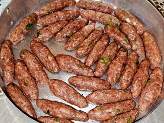Arabic cuisine traditional food beef Kofta, kebab kofta shish which is minced meat grilled or cooked, oriental baked meat food, tray of kofta ready to be baked in the oven