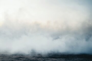 A cloudy sky with a foggy mist over the ocean. Ground fog swirling smoke rolling low across the ground.
