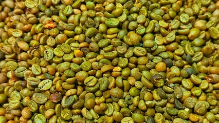 Fresh dry green coffee beans as background. Dried green coffee beans. Close up of green coffee beans. Unroasted coffee beans.