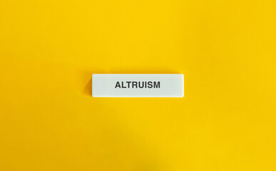 The word “Altruism” displayed on a wide letter tile against a vibrant yellow background.