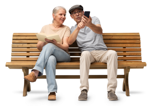 Mature couple sitting together on a wooden bench, woman reading a book and man using a smartphone. Studio image isolated on white background. Casual outfits, man wearing reading glasses and a hat
