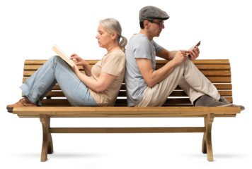 Mature couple sitting back to back on a wooden bench, woman reading book and man using smartphone. Concept of  emotional distance in modern relationships. Studio shot isolated on white background.