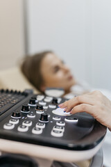 Close-up of ultrasound machine as medical worker performs scan. Concept medical imaging and...