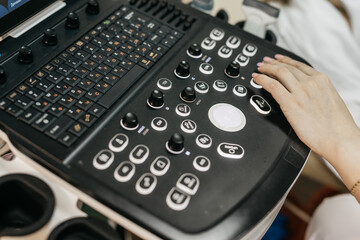 Close-up of ultrasound machine as medical worker performs scan. Concept medical imaging and...