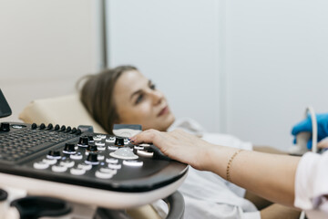Close-up of ultrasound machine as medical worker performs scan. Concept medical imaging and...