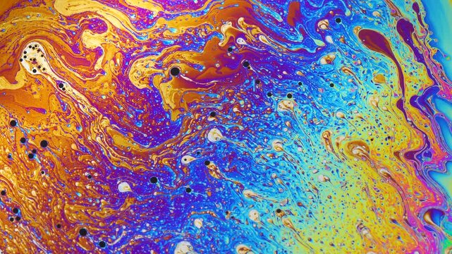 Macro photo of vibrant soap bubble texture with swirling rainbow hues and fluid abstract patterns in bright iridescent tones