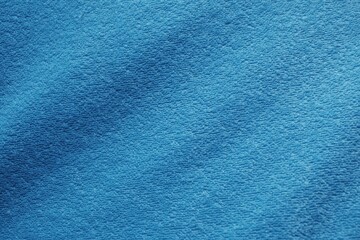 Close-up of blue towel fabric, dark blue, background