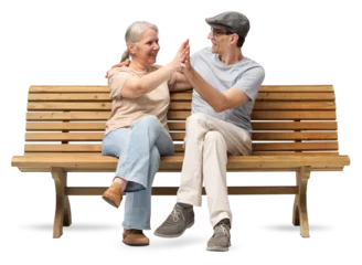 Fototapete Happy mature couple sitting on a wooden bench, embracing and smiling with joy. A cheerful and affectionate moment together. Studio shot isolated on white background. Both are casually dressed. © amedeoemaja