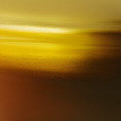 A yellow and brown background with a reflection of the sky