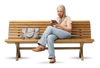 A mature woman in her 50s sits on a wooden bench, reading an e-book on an e-reader. Studio shot isolated on a white background. She is dressed casually