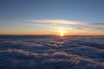 Sunset over clouds with mountains in distance sky above