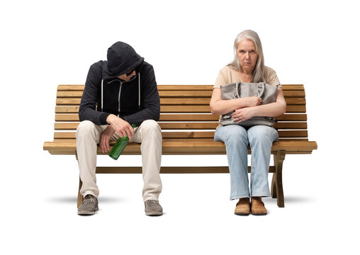 Scared mature woman sitting on a bench, clutching her handbag tightly. Next to her sits a suspicious man in a hoodie. Concept of urban insecurity, fear and street danger. Isolated on white background