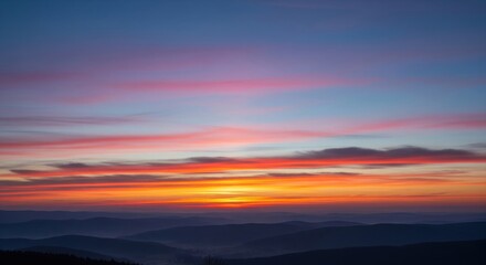 Obraz premium Serene Sunrise Over Layered Mountain Ranges