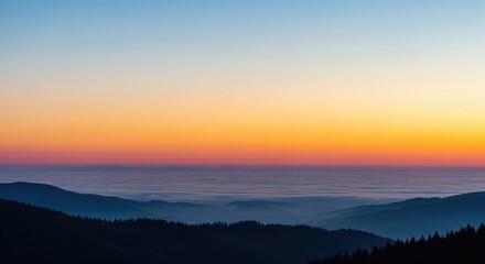 Obraz premium Serene Sunset Over Misty Mountain Ranges