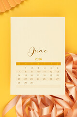 June 2026 calendar page with yellow ribbon on yellow background.