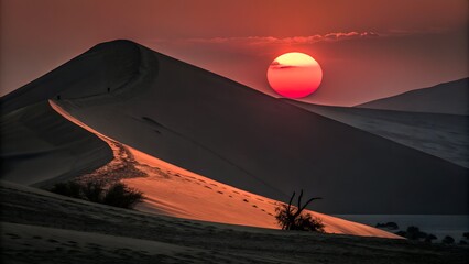 Majestic desert dunes glow orange and red under a brilliant setting sun, casting long dramatic shadows across the vast landscape.