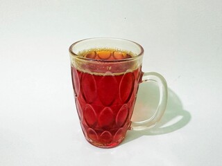 Cold turmeric drink, glass cup of turmeric drink. Glass of healthy turmeric drink on white background. Turmeric drink made from spices and can be used as medicine.