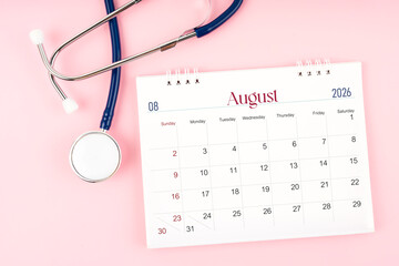 Blank August 2026 desk calendar and stethoscope, Medical appointment schedule to check up.