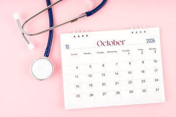 Blank October 2026 desk calendar and stethoscope, Medical appointment schedule to check up.