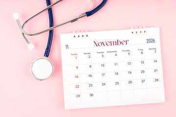 Blank November 2026 desk calendar and stethoscope, Medical appointment schedule to check up.