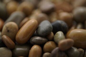 Smooth multicolored pebbles in various shades of brown, gray and black. Ideal for nature, relaxation or spa style decorating. Sea stones