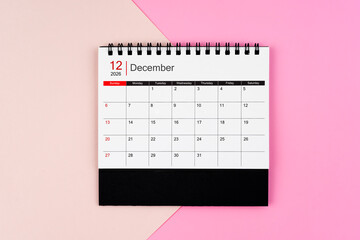 December 2026 desk calendar on pink background, Position is center of frame.
