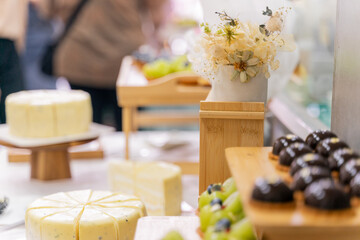 A colorful and delicious buffet spread featuring a wide variety of international dishes, including fizzy cola, lemon tart, creamy cheesecake, blueberry tart, crispy fried chicken, and savory pasta