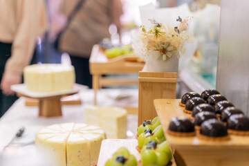 A colorful and delicious buffet spread featuring a wide variety of international dishes, including fizzy cola, lemon tart, creamy cheesecake, blueberry tart, crispy fried chicken, and savory pasta