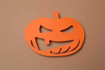 Halloween with orange pumpkins, black bats, autumn leaves on beige background