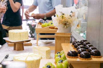 A colorful and delicious buffet spread featuring a wide variety of international dishes, including fizzy cola, lemon tart, creamy cheesecake, blueberry tart, crispy fried chicken, and savory pasta