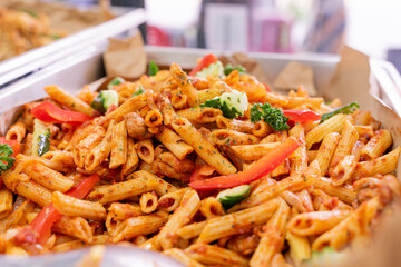 A colorful and delicious buffet spread featuring a wide variety of international dishes, including fizzy cola, lemon tart, creamy cheesecake, blueberry tart, crispy fried chicken, and savory pasta