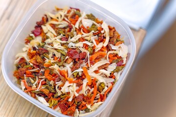Dried vegetable mix for soups containing onions, carrots, peppers and other vegetables in a plastic...