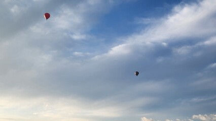 Colorful Hot Air Balloons flying over neighborhood