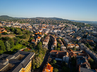 Drone photo from Castle District facing inland over Buda neighborhoods, showing Csalogány Street...