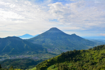 Panoramic view of mountainous landscapes, with a prominent volcanic peak dominating the horizon,...