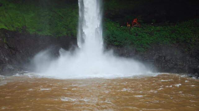 4K Closeup Slow motion shot of Devkund waterfall falling above the pool of the water at Raigad district in Maharashtra, India. Fog rises due to the striking of forceful waterfall in the pool. 