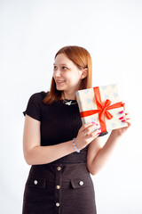 red-haired teen girl with a gift in her hands on a white background
