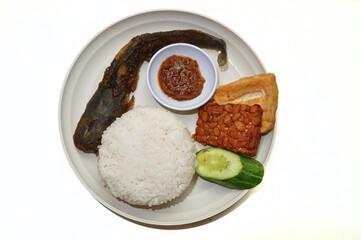 Indonesian Nasi Uduk with Fried Catfish and Side Dishes on White Plate
