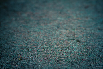 Extreme closeup of turquoise handmade paper with shallow depth of field.